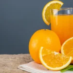 glass-orange-juice-placed-wood