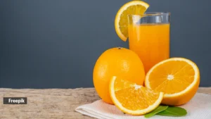 glass-orange-juice-placed-wood