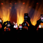 Streaming a music concert to social media via smartphone.